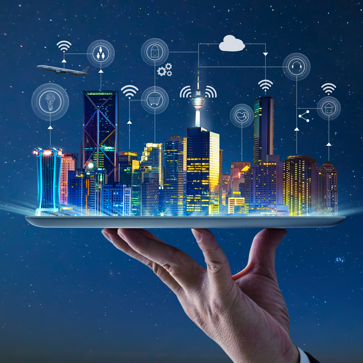 The benefits of IoT in smart cities are illustrated with a city sitting on top of a tablet.